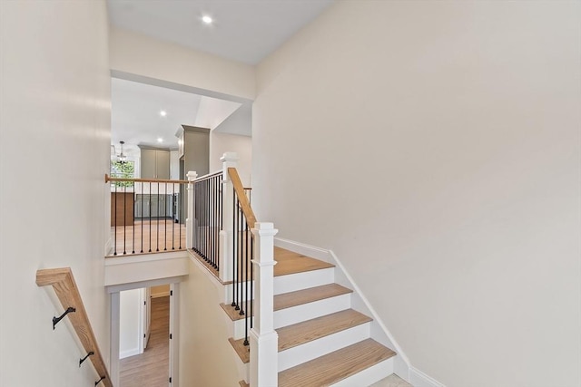 stairway featuring baseboards and recessed lighting