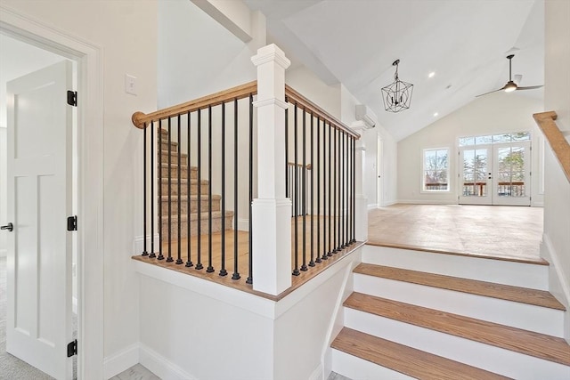 staircase featuring french doors, a notable chandelier, baseboards, vaulted ceiling, and a wall mounted AC
