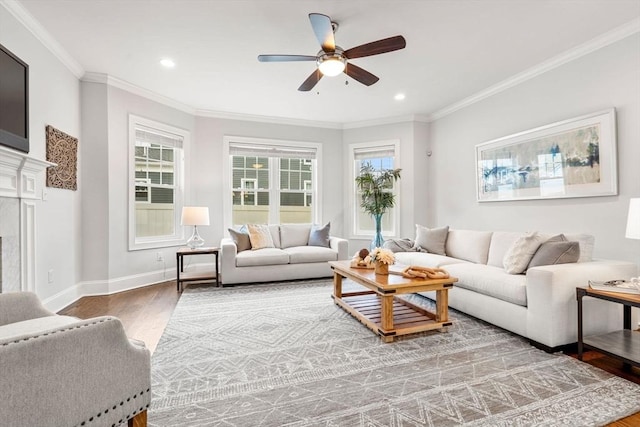 living room featuring ceiling fan, a fireplace, crown molding, and hardwood / wood-style floors