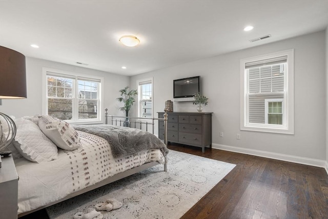 bedroom with dark wood-type flooring