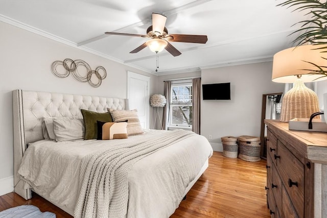 bedroom with light wood-type flooring, ceiling fan, and ornamental molding