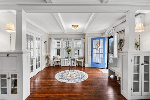 foyer featuring french doors, ornate columns, and wood finished floors