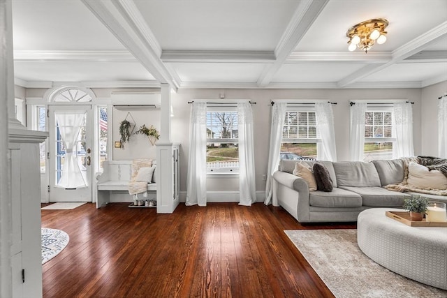 living area with hardwood / wood-style flooring, an AC wall unit, and beamed ceiling