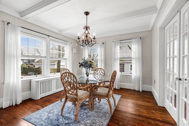 dining room featuring baseboards, an inviting chandelier, beamed ceiling, wood finished floors, and radiator heating unit