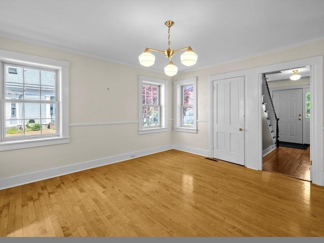14 Parkman St, Westborough, MA 01581 - unfurnished dining area featuring stairway, light wood-type flooring, baseboards, and ornamental molding