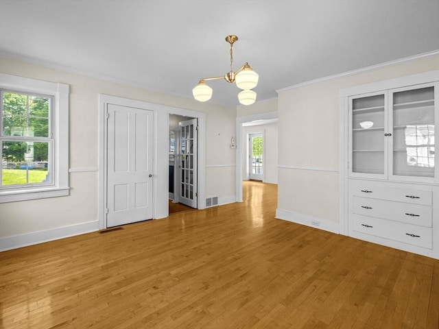 14 Parkman St, Westborough, MA 01581 - unfurnished dining area with light wood finished floors, a chandelier, baseboards, and ornamental molding