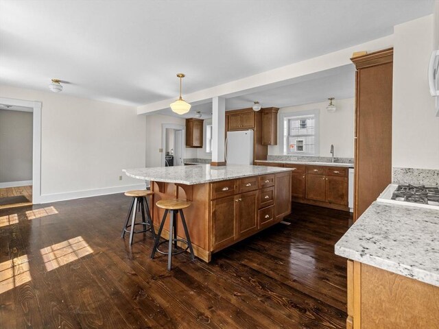 14 Parkman St, Westborough, MA 01581 - kitchen with freestanding refrigerator, a center island, dark wood-style flooring, and a sink