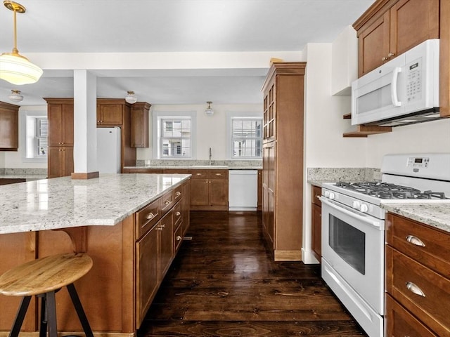 14 Parkman St, Westborough, MA 01581 - kitchen with white appliances, a sink, dark wood finished floors, brown cabinets, and light stone counters