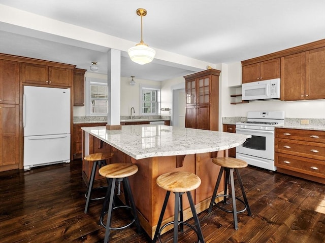 14 Parkman St, Westborough, MA 01581 - kitchen featuring white appliances, a sink, dark wood finished floors, and a breakfast bar