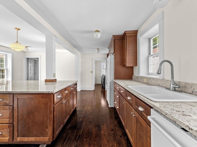14 Parkman St, Westborough, MA 01581 - kitchen with a sink, white appliances, dark wood-style flooring, light stone counters, and pendant lighting