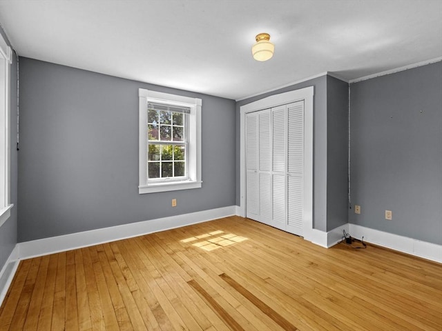 14 Parkman St, Westborough, MA 01581 - unfurnished bedroom with a closet, hardwood / wood-style floors, and baseboards