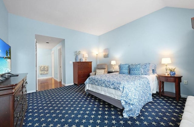 bedroom featuring vaulted ceiling and carpet floors