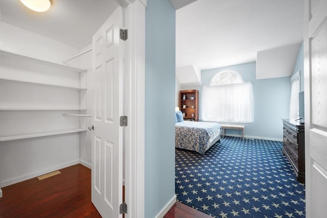 bedroom with dark colored carpet