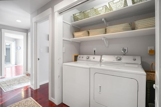 laundry room featuring dark hardwood / wood-style floors and washer and clothes dryer