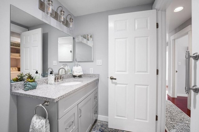 bathroom featuring hardwood / wood-style flooring and vanity