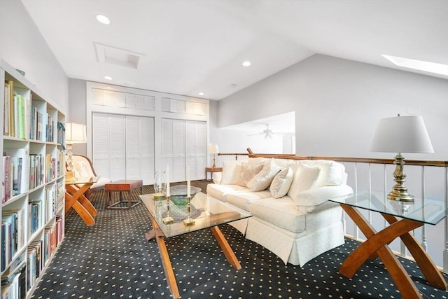 carpeted living room with vaulted ceiling with skylight