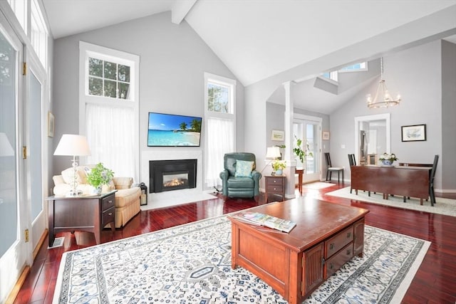 living room featuring a healthy amount of sunlight, dark hardwood / wood-style floors, and high vaulted ceiling