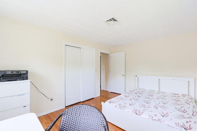 bedroom with light wood-style flooring and a closet