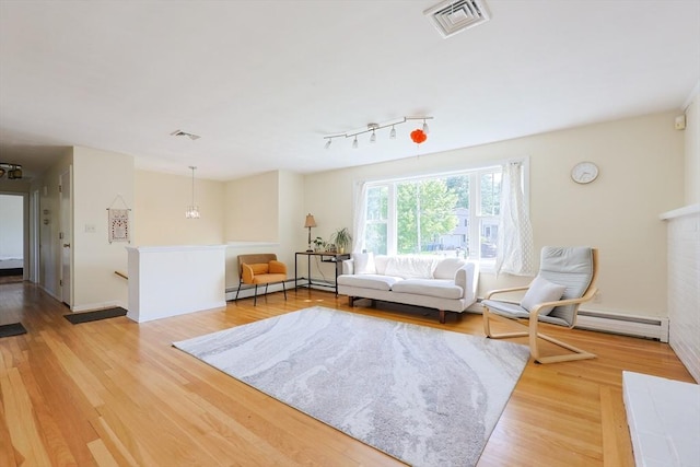 living area featuring light wood finished floors and baseboards