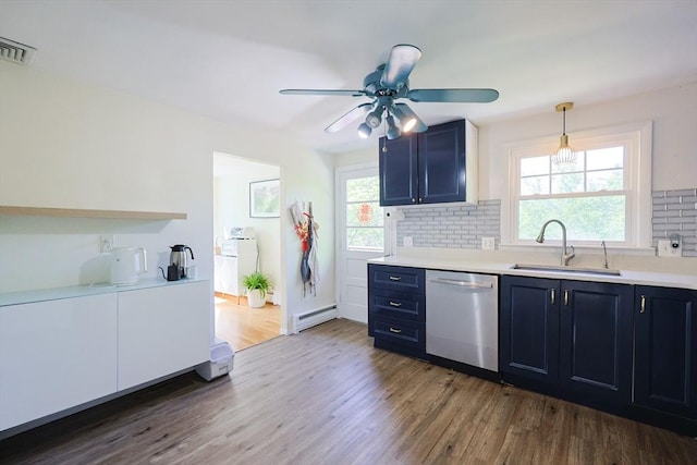 kitchen with dishwasher, a sink, blue cabinetry, a baseboard radiator, and wood finished floors