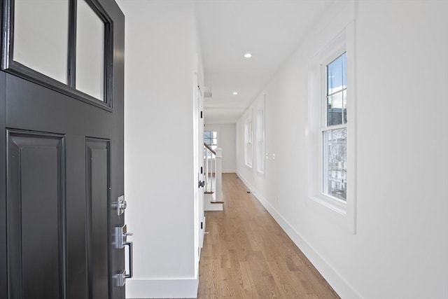 corridor with light hardwood / wood-style flooring