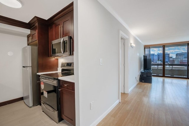 kitchen with appliances with stainless steel finishes, decorative backsplash, expansive windows, ornamental molding, and light hardwood / wood-style flooring