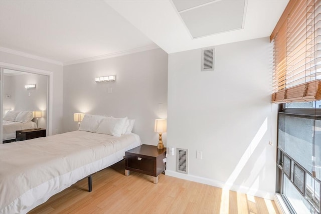 bedroom featuring crown molding and wood-type flooring