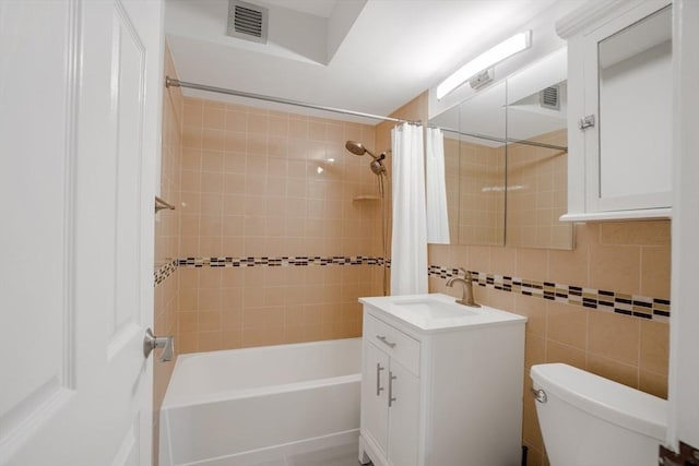 full bathroom with tile walls, shower / tub combo, vanity, tasteful backsplash, and toilet