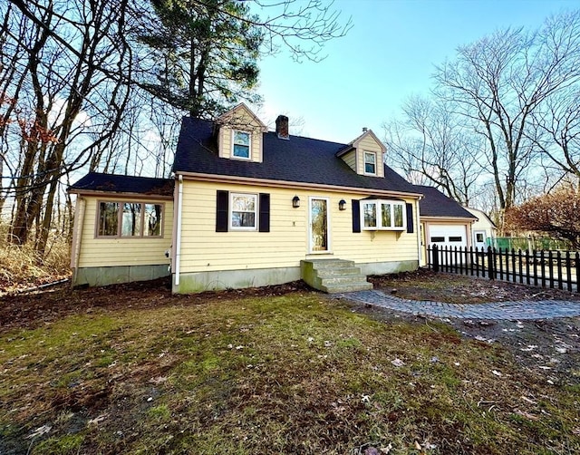 cape cod-style house with a garage and a front yard