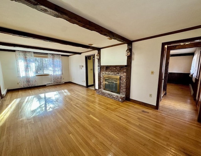 unfurnished living room with beamed ceiling, light hardwood / wood-style floors, and a brick fireplace