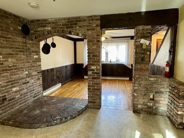 interior space featuring ceiling fan and ornate columns