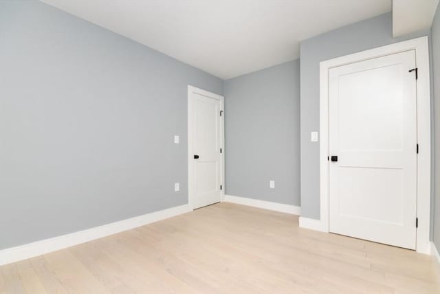 empty room with light hardwood / wood-style flooring