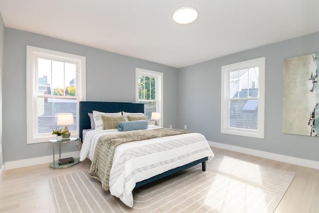 bedroom featuring wood-type flooring and multiple windows