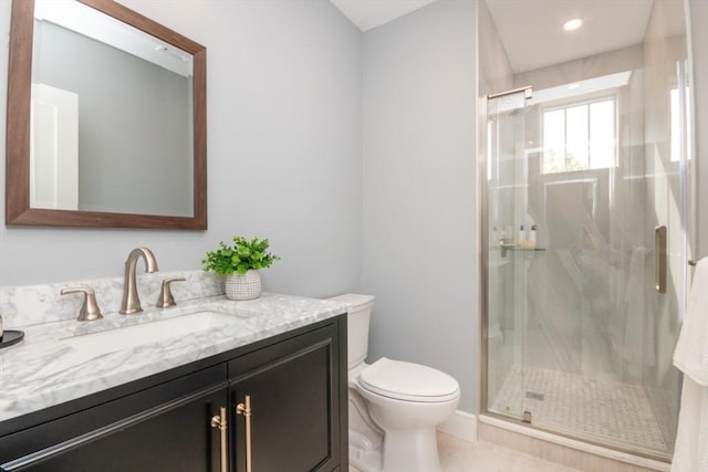 bathroom featuring walk in shower, tile patterned floors, vanity, and toilet