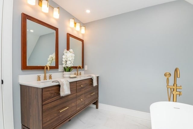 bathroom with vanity and a bath