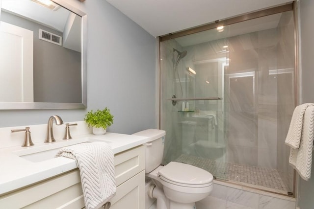 bathroom with vanity, a shower with shower door, and toilet