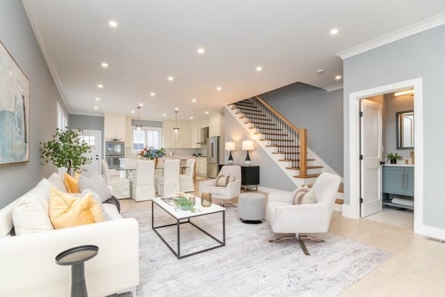 living room with ornamental molding and light wood-type flooring