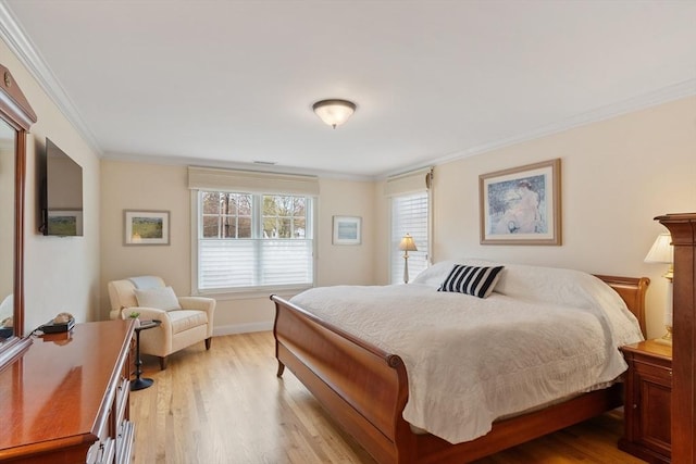 bedroom featuring crown molding, wood finished floors, and baseboards
