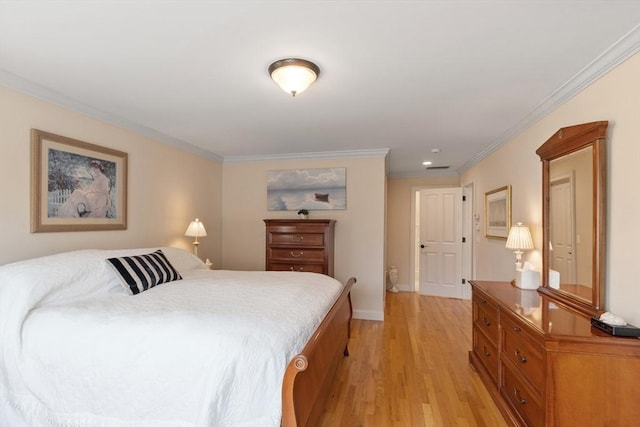 bedroom featuring light wood-style flooring, crown molding, and baseboards