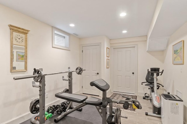 workout room featuring baseboards and recessed lighting