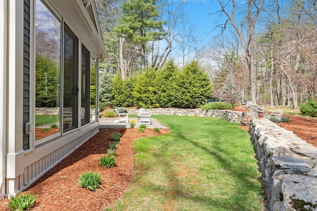 view of grassy yard with a patio