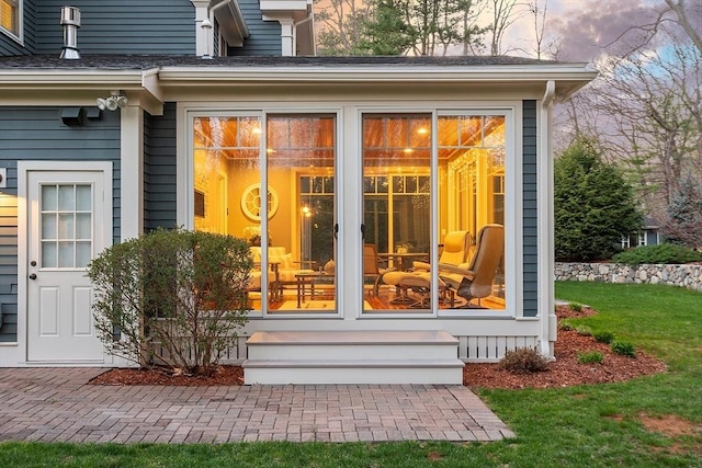 doorway to property with a yard