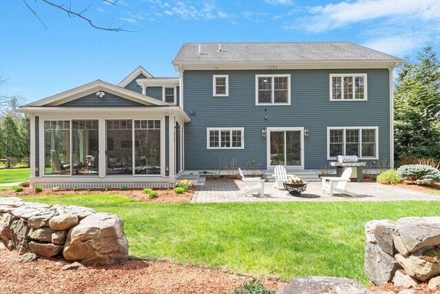back of house with a patio, a sunroom, a fire pit, and a yard