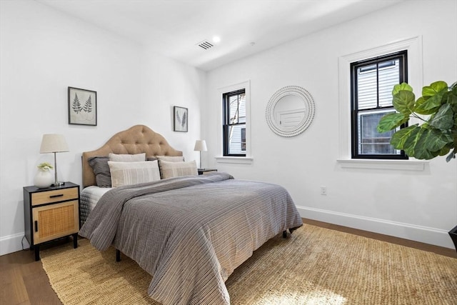 43 Wendell St Unit 0, Cambridge, MA 02138 - bedroom featuring baseboards, wood finished floors, visible vents, and multiple windows