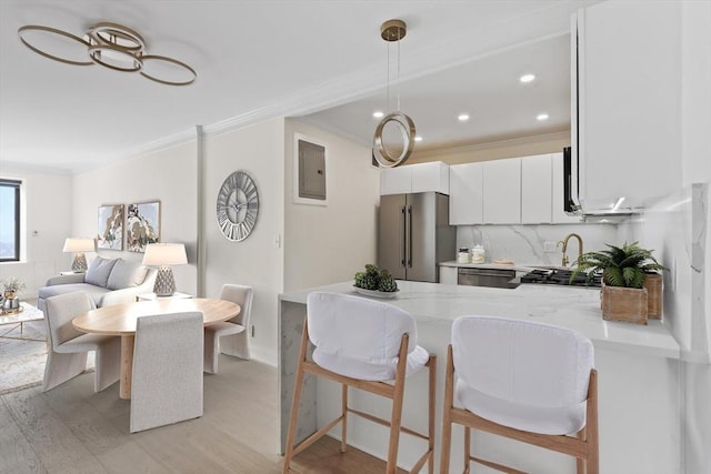 85 E India Row Unit 36D, Boston, MA 02110 - kitchen with high quality fridge, crown molding, a peninsula, light wood finished floors, and white cabinets