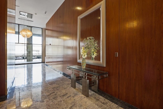 85 E India Row Unit 36D, Boston, MA 02110 - hallway featuring wooden walls, a chandelier, and expansive windows