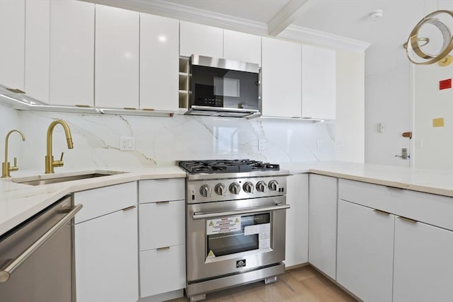 85 E India Row Unit 36D, Boston, MA 02110 - kitchen with appliances with stainless steel finishes, a sink, tasteful backsplash, white cabinets, and ornamental molding