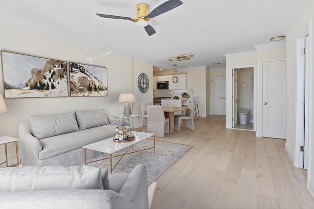 85 E India Row Unit 36D, Boston, MA 02110 - living room with a ceiling fan, light wood-style floors, crown molding, and baseboards