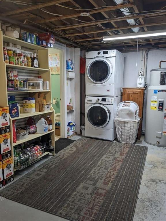 laundry room with stacked washing maching and dryer and water heater