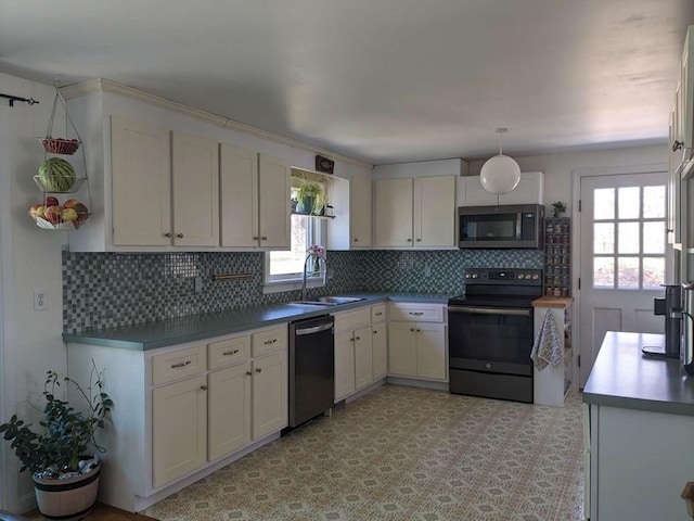 kitchen featuring a wealth of natural light, sink, white cabinets, and appliances with stainless steel finishes